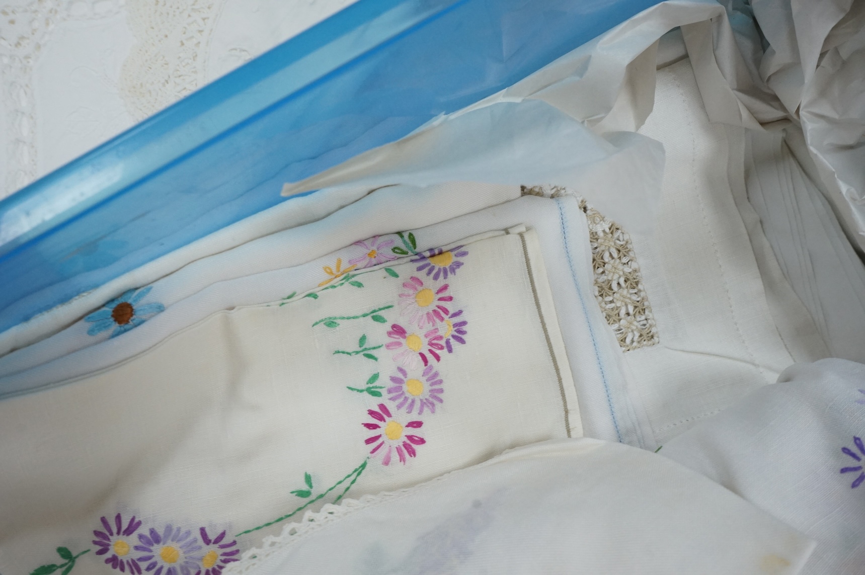 A collection of early 20th century and later crochet, cut work and drawn thread table linens and a large embroidered table cloth